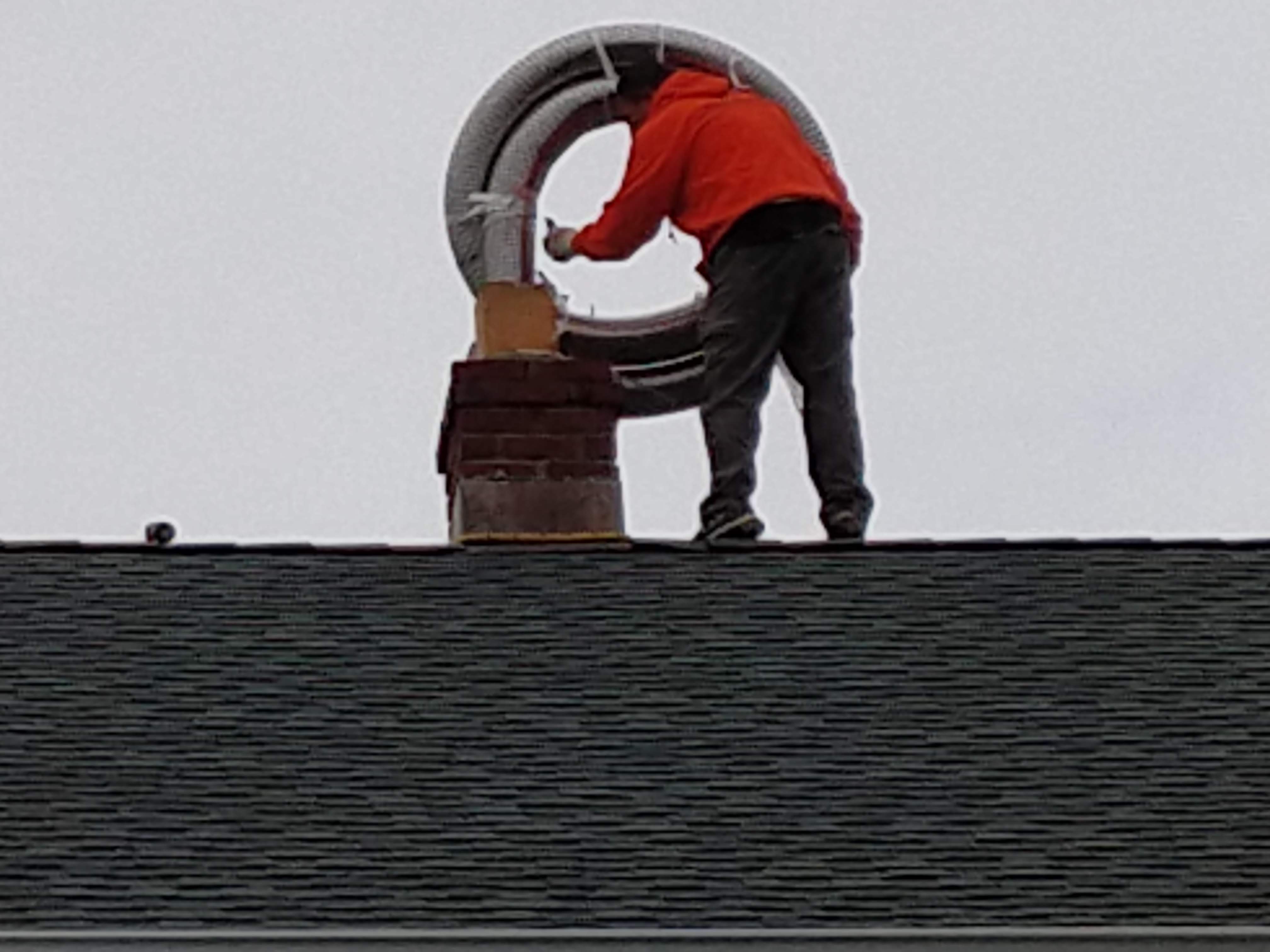 Flexible stainless chimney liner being installed in Hampton Bays, New York